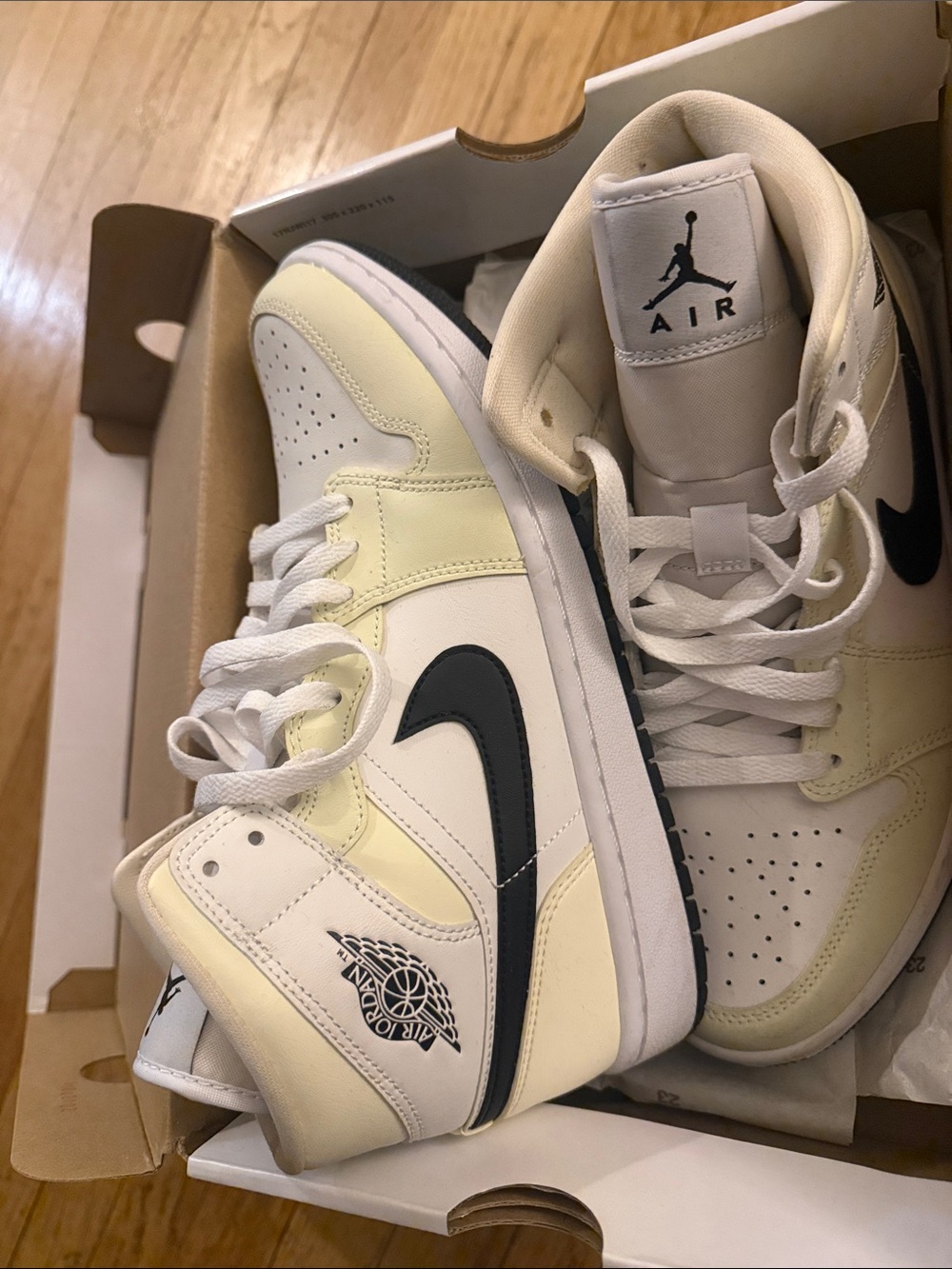 Jordan 1 Women’s Mid-Top Sneakers in Cream and Black